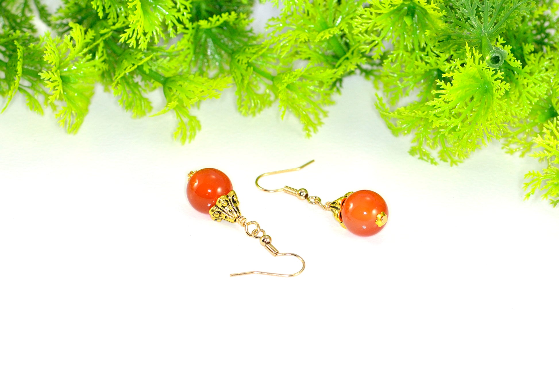 Close up of 12mm Natural Carnelian Crystal Drop Earrings.