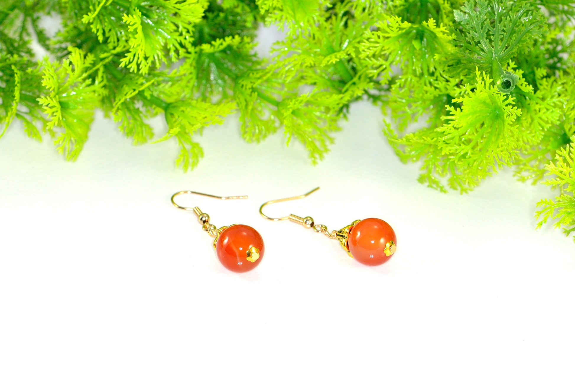 Close up of 12mm Natural Carnelian Crystal Drop Earrings.