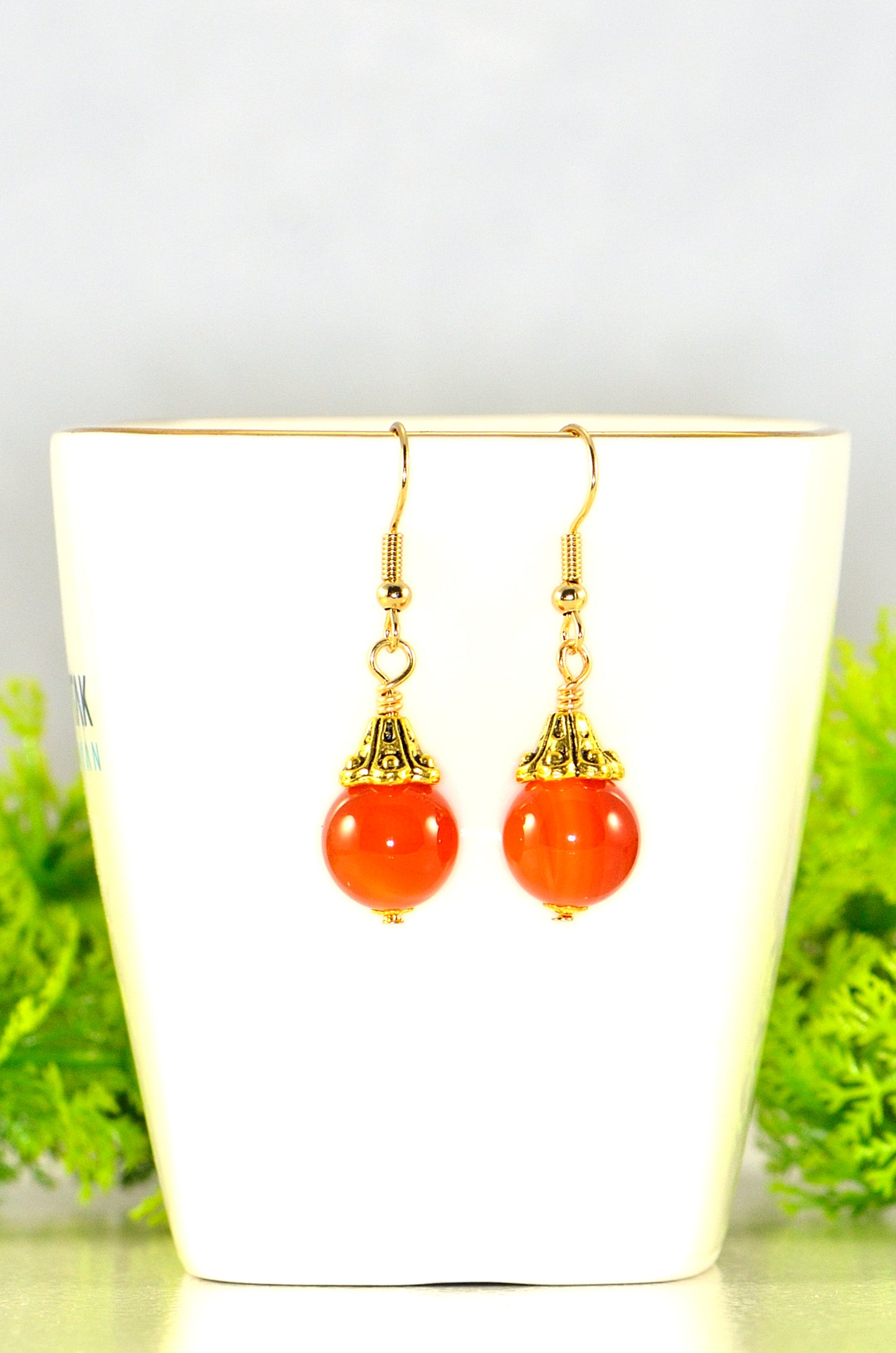 Close up of 12mm Natural Carnelian Crystal Drop Earrings.