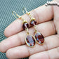 Close up of Brown Oval Glass Dangle Earrings.