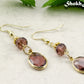 Brown Oval Glass Dangle Earrings with gold tone ear wires.