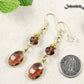 Brown Oval Glass Dangle Earrings beside a dime.