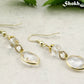 Clear Oval Glass Dangle Earrings with gold tone ear wires.