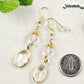 Clear Oval Glass Dangle Earrings beside a dime.