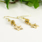 Close up of Sparkly Rhinestone and Gold Star Earrings.