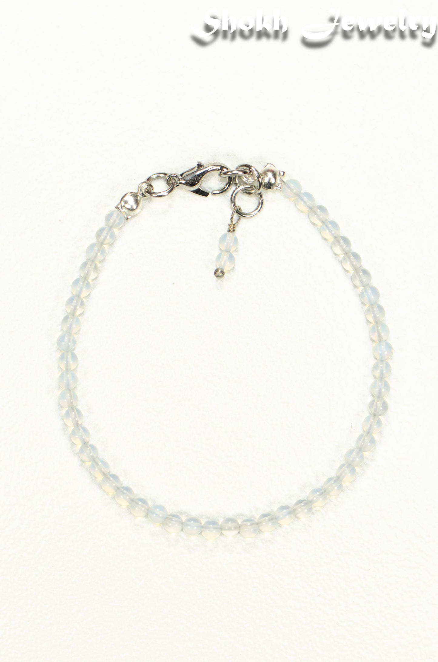 Top view of 3mm Clear White Opalite Anklet on white background.