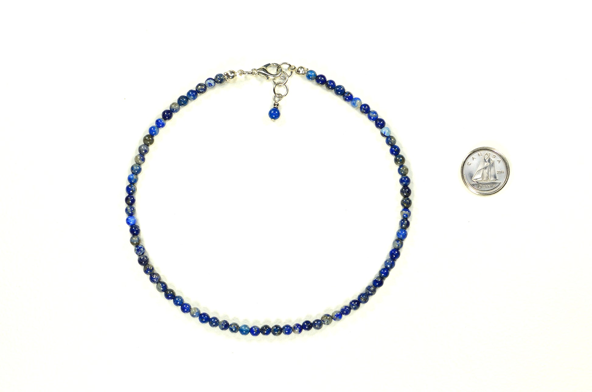 4mm Natural Lapis Lazuli Choker Necklace beside a dime.