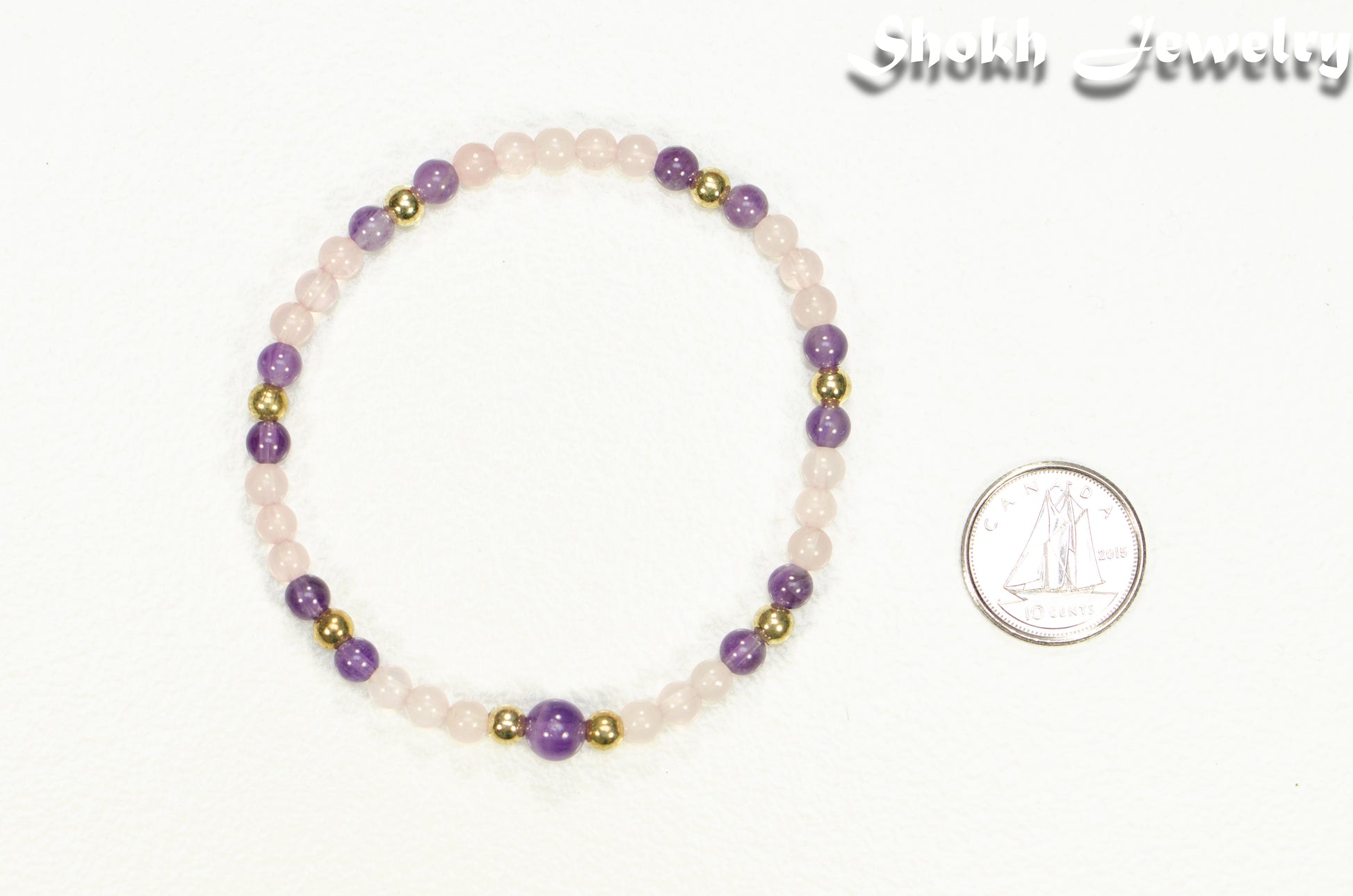 4mm Rose Quartz and Amethyst Bracelet beside a dime.