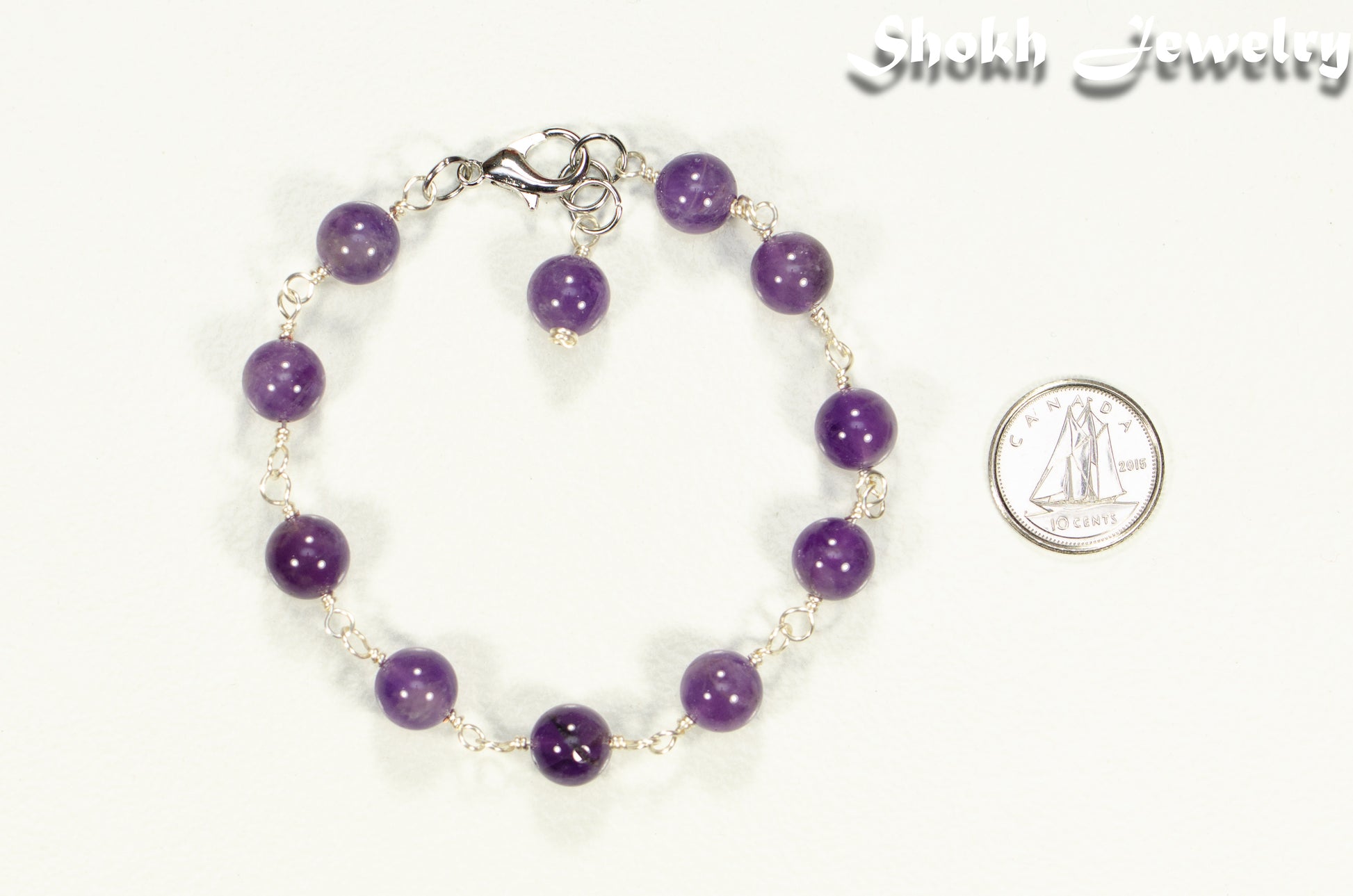 8mm Amethyst Link Chain Anklet beside a dime.