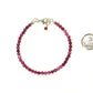 Faceted Ruby Bracelet with Sterling Silver Clasp beside a dime.