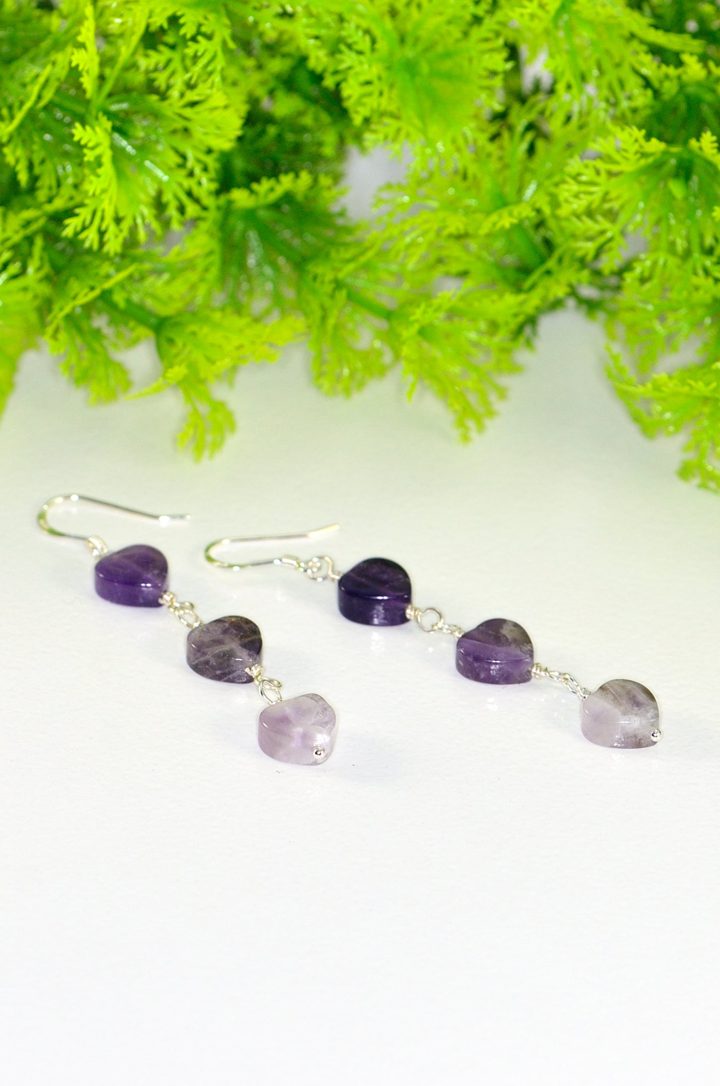 Close up of Natural Amethyst Heart Dangle Earrings.