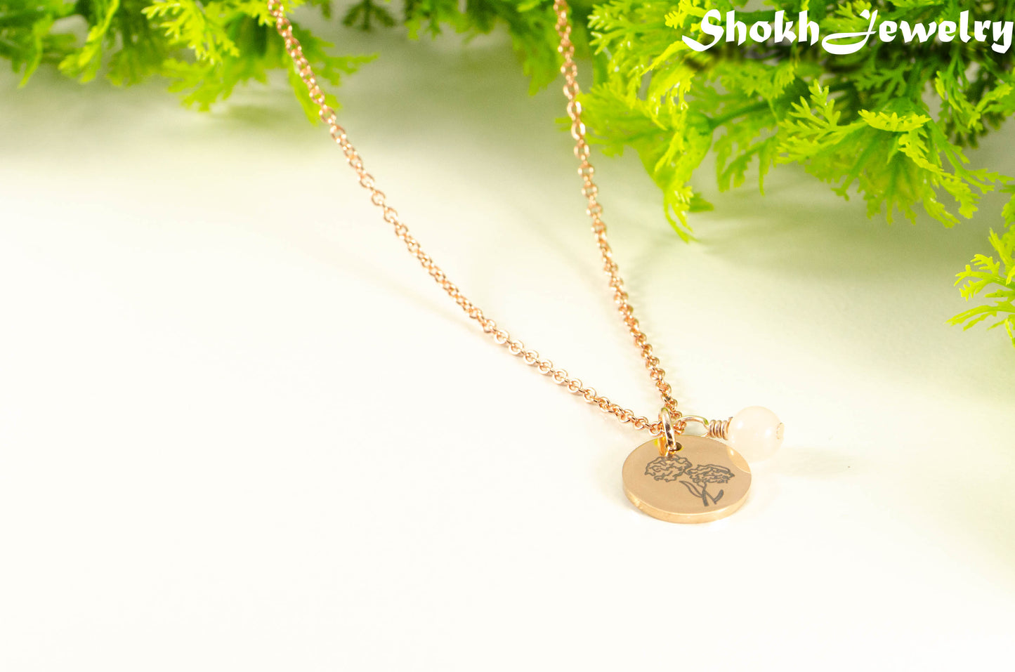 Close up of Rose Gold Plated October Birth Flower Necklace with Rose Quartz Birthstone Pendant.