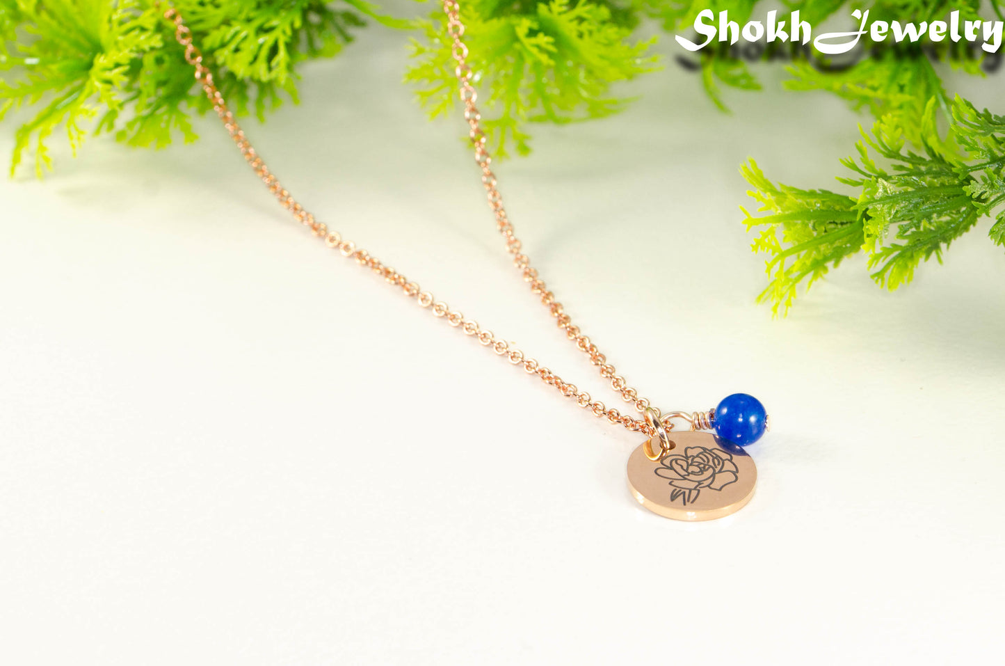 Close up of Rose Gold Plated September Birth Flower Necklace with Sapphire Birthstone Pendant.