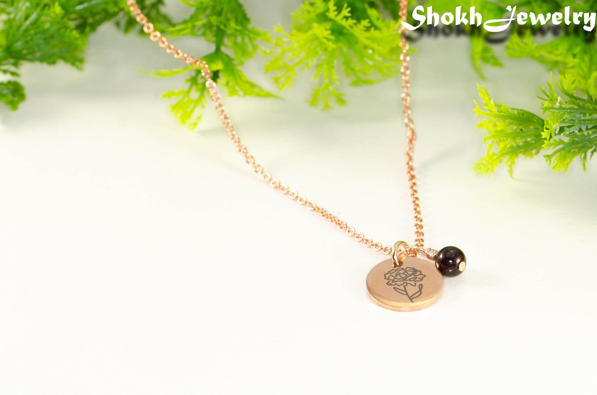 Close up of Rose Gold Plated January Birth Flower Necklace with Garnet Birthstone Pendant.