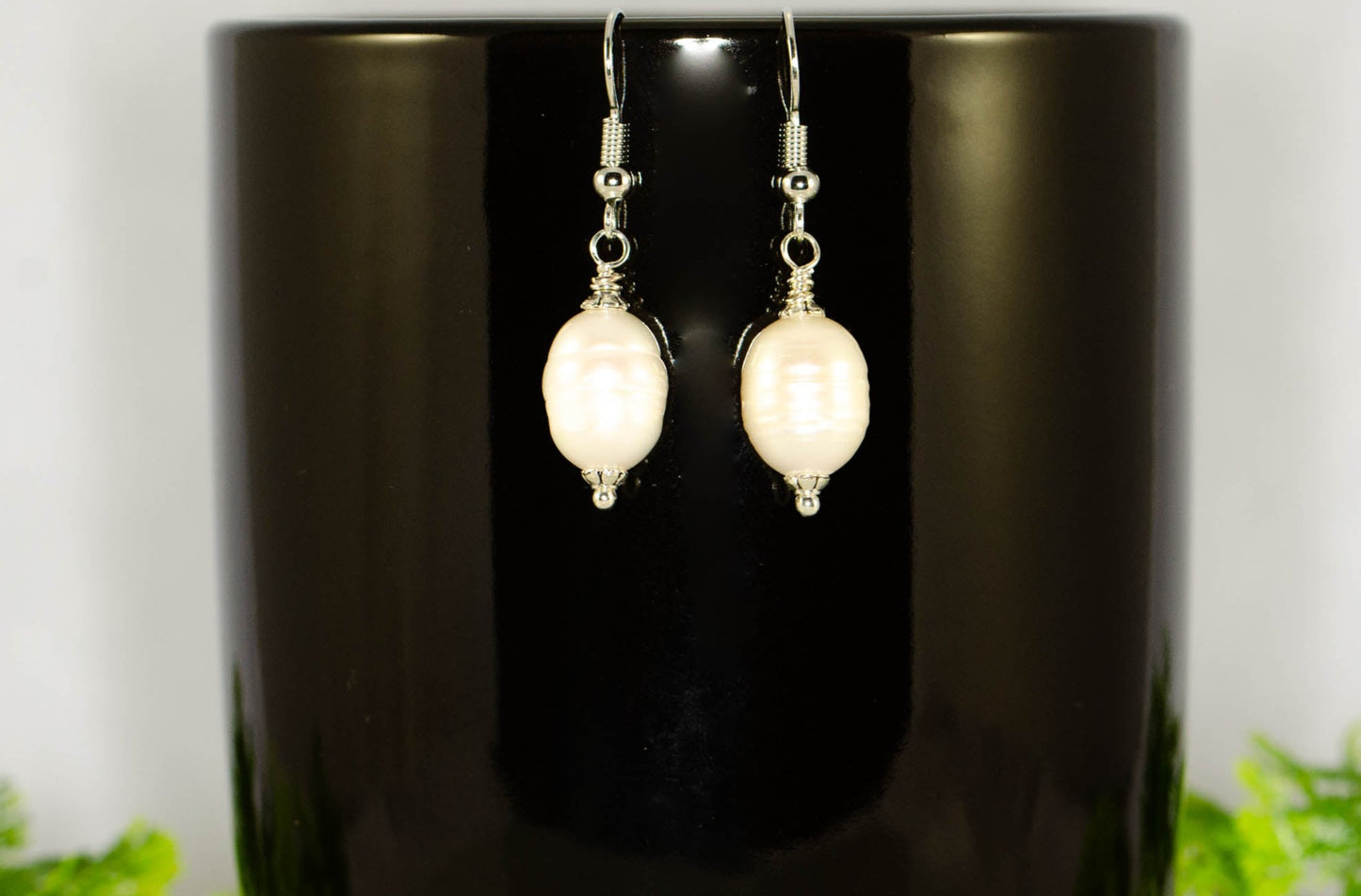 12mm Natural Freshwater Pearl Earrings displayed on a coffee mug.