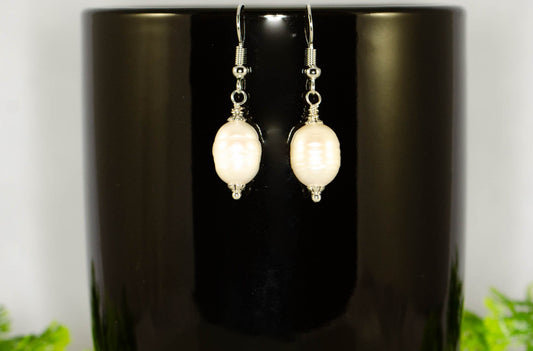 12mm Natural Freshwater Pearl Earrings displayed on a coffee mug.