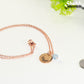 Rose Gold Plated March Birth Flower Necklace with Aquamarine Birthstone Pendant beside a dime.