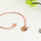 Rose Gold Plated October Birth Flower Necklace with Rose Quartz Birthstone Pendant beside a dime.
