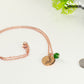 Rose Gold Plated May Birth Flower Necklace with Emerald Birthstone Pendant beside a dime.
