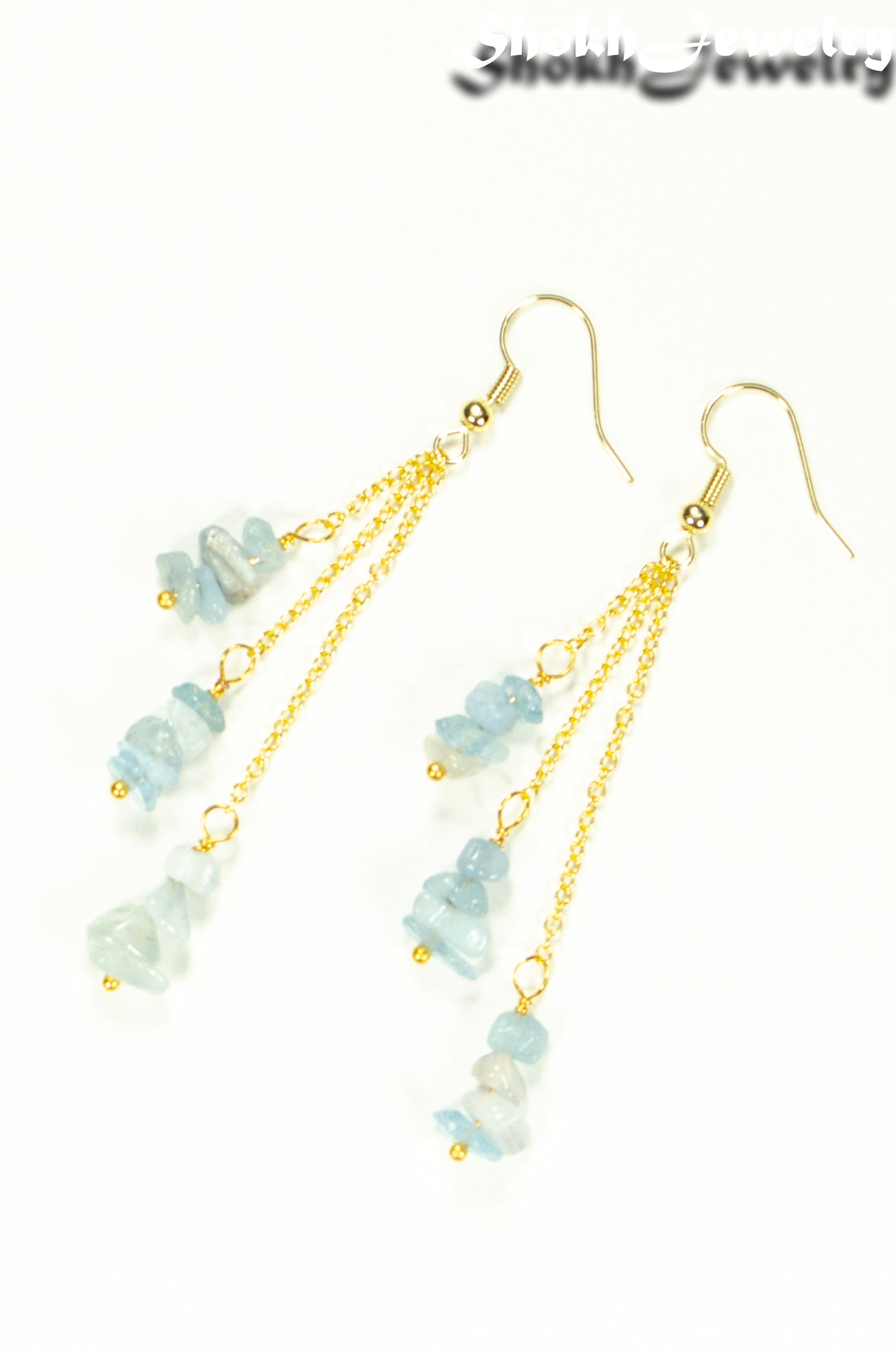 Top view of Long Gold Plated Chain and Aquamarine Crystal Chip Earrings.