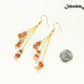 Long Gold Plated Chain and Carnelian Crystal Chip Earrings beside a dime.