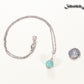 12mm Turquoise Howlite Pendant Necklace beside a dime.