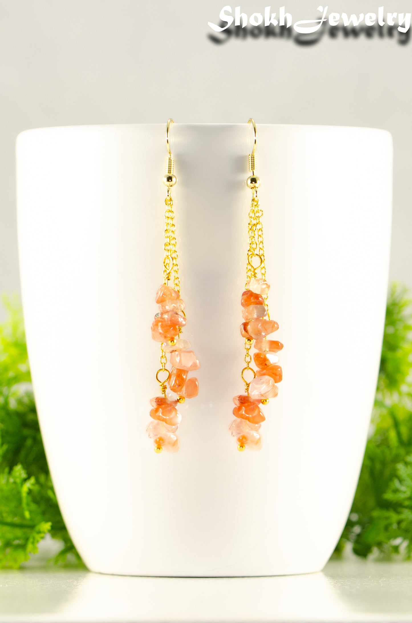 Close up of Long Gold Plated Chain and Carnelian Crystal Chip Earrings.