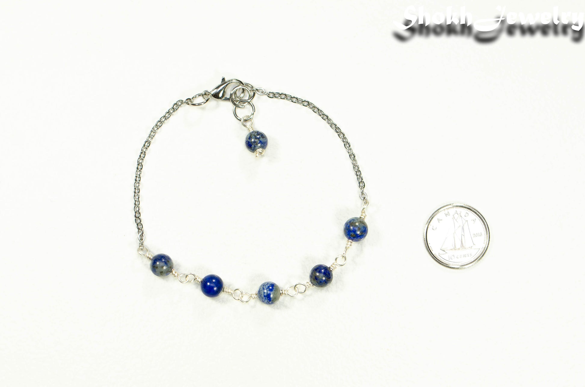 Lapis Lazuli and Stainless Steel Chain Anklet beside a dime.