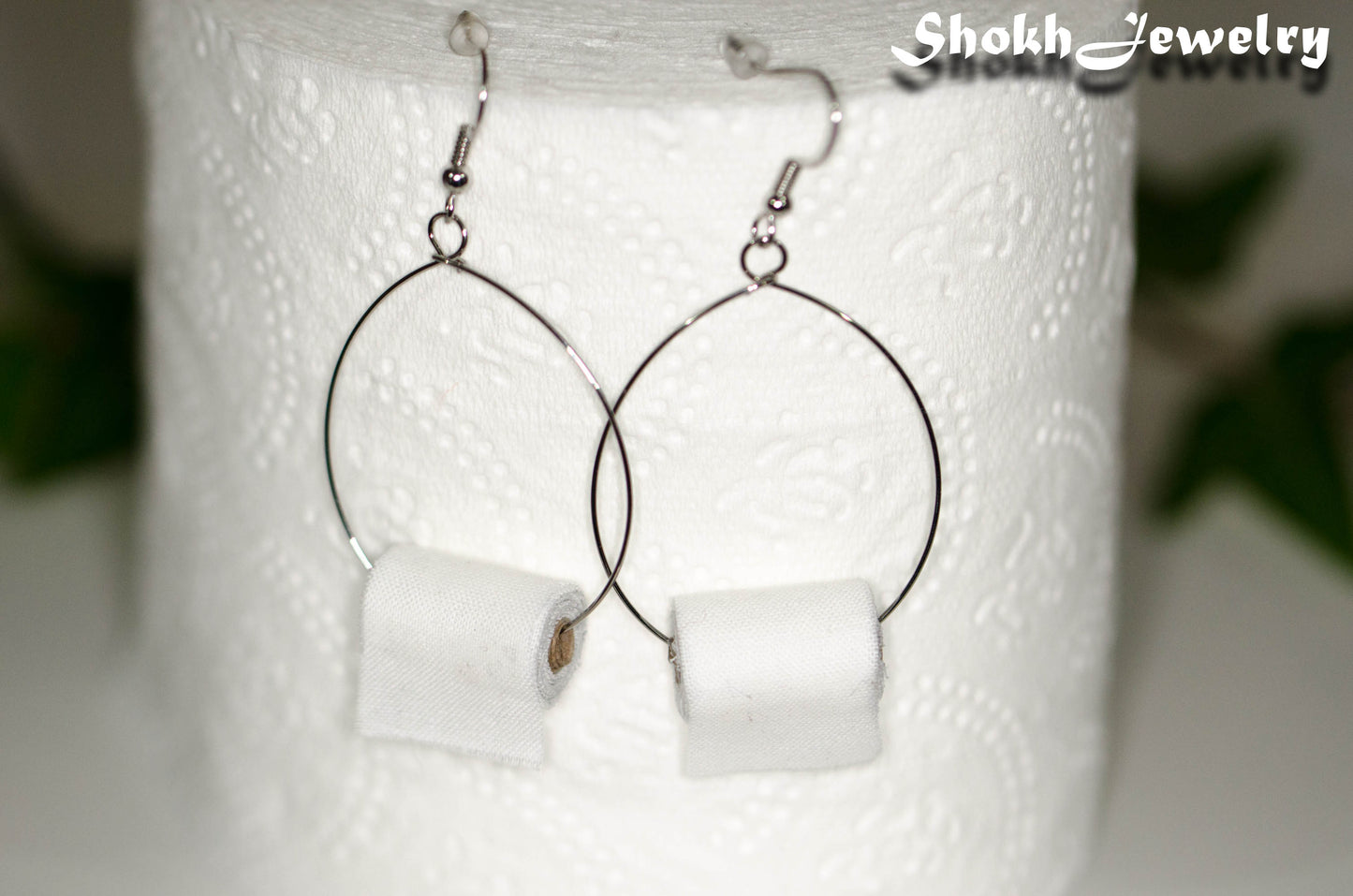Large Miniature Toilet Paper Roll Earrings displayed  on a toilet paper roll.