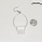 Large Miniature Toilet Paper Roll Earring beside a dime.