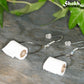 Close up of Miniature Toilet Paper Roll Earrings.
