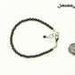 4mm Hematite Stone Bracelet with Clasp beside a dime.