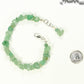 Natural Green Aventurine Crystal Chip Bracelet beside a dime.