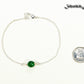 Minimal Green Emerald Bracelet beside a dime.