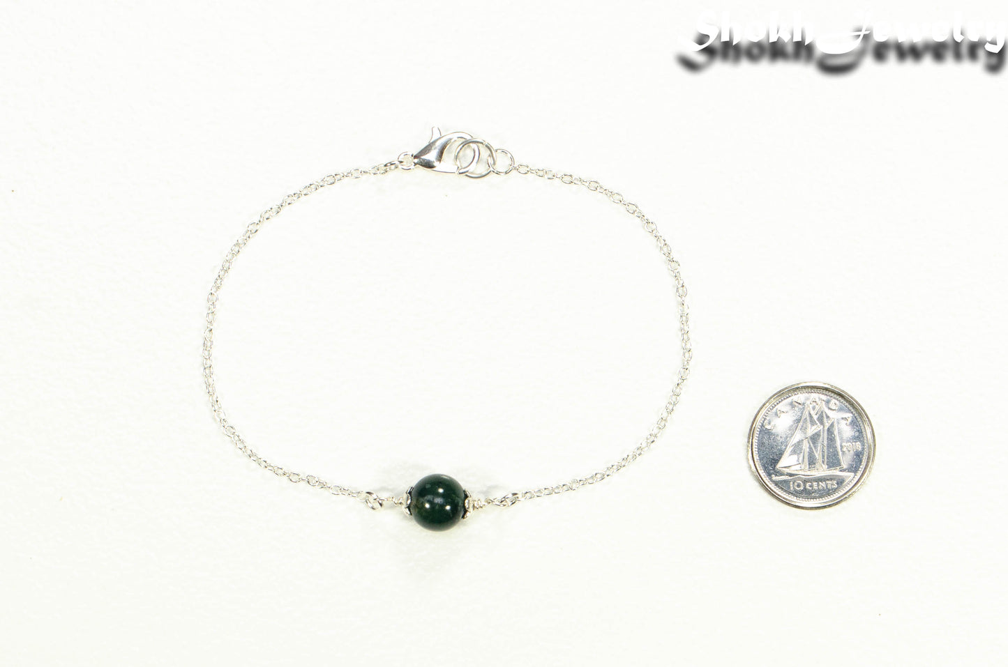Minimal Moss Agate Bracelet beside a dime.