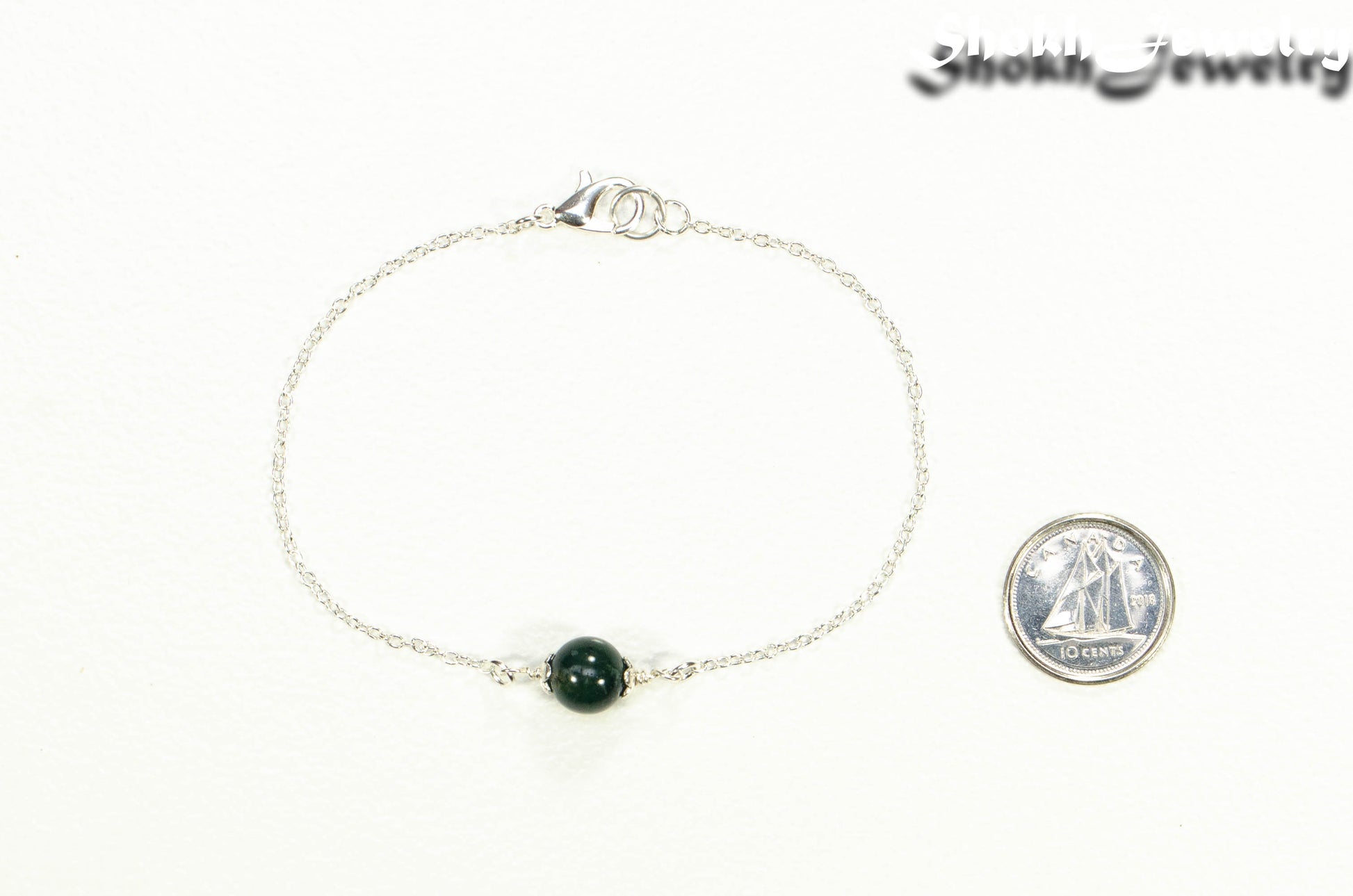 Minimal Moss Agate Bracelet beside a dime.
