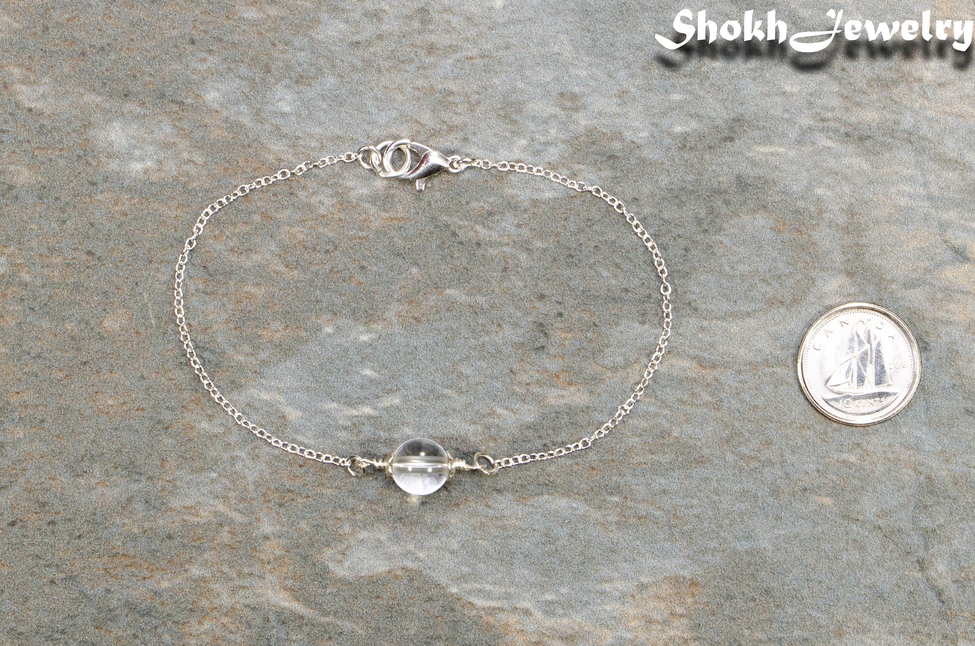 Minimal Clear Quartz Bracelet beside a dime.
