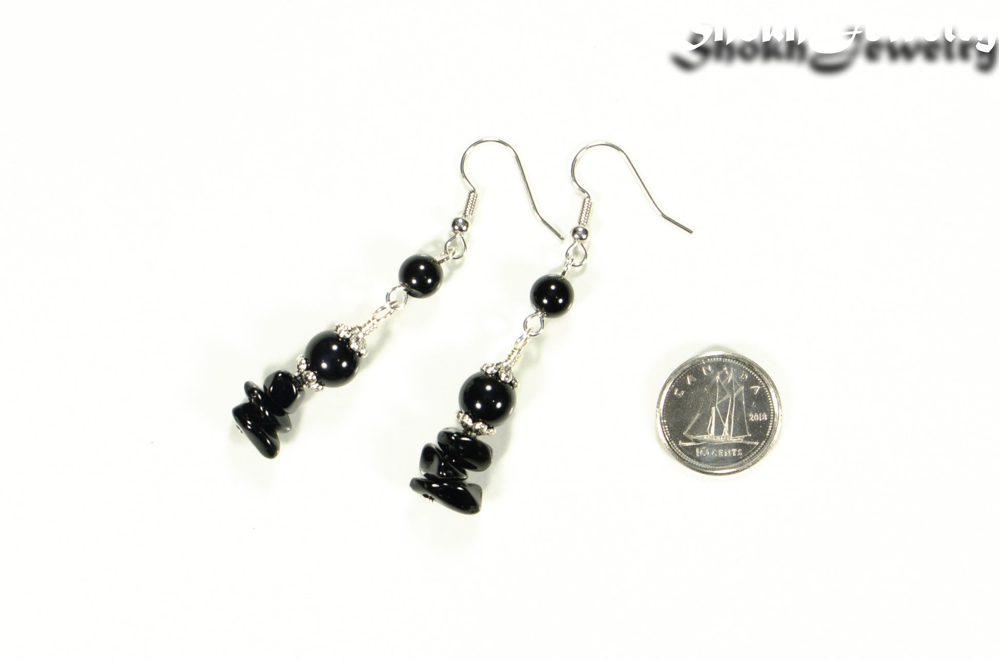Long Black Obsidian Crystal Chip Earrings beside a dime.