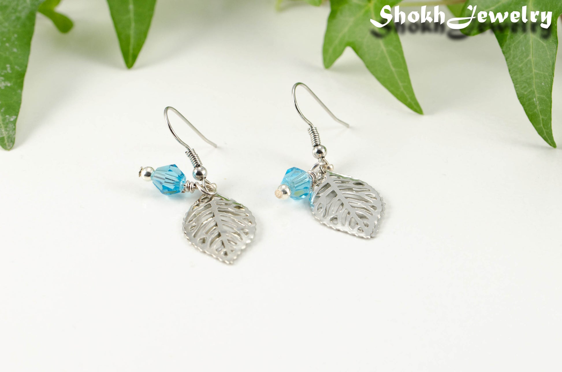 Filigree Leaf Charm and Aqua Blue Glass Crystal Earrings for women.