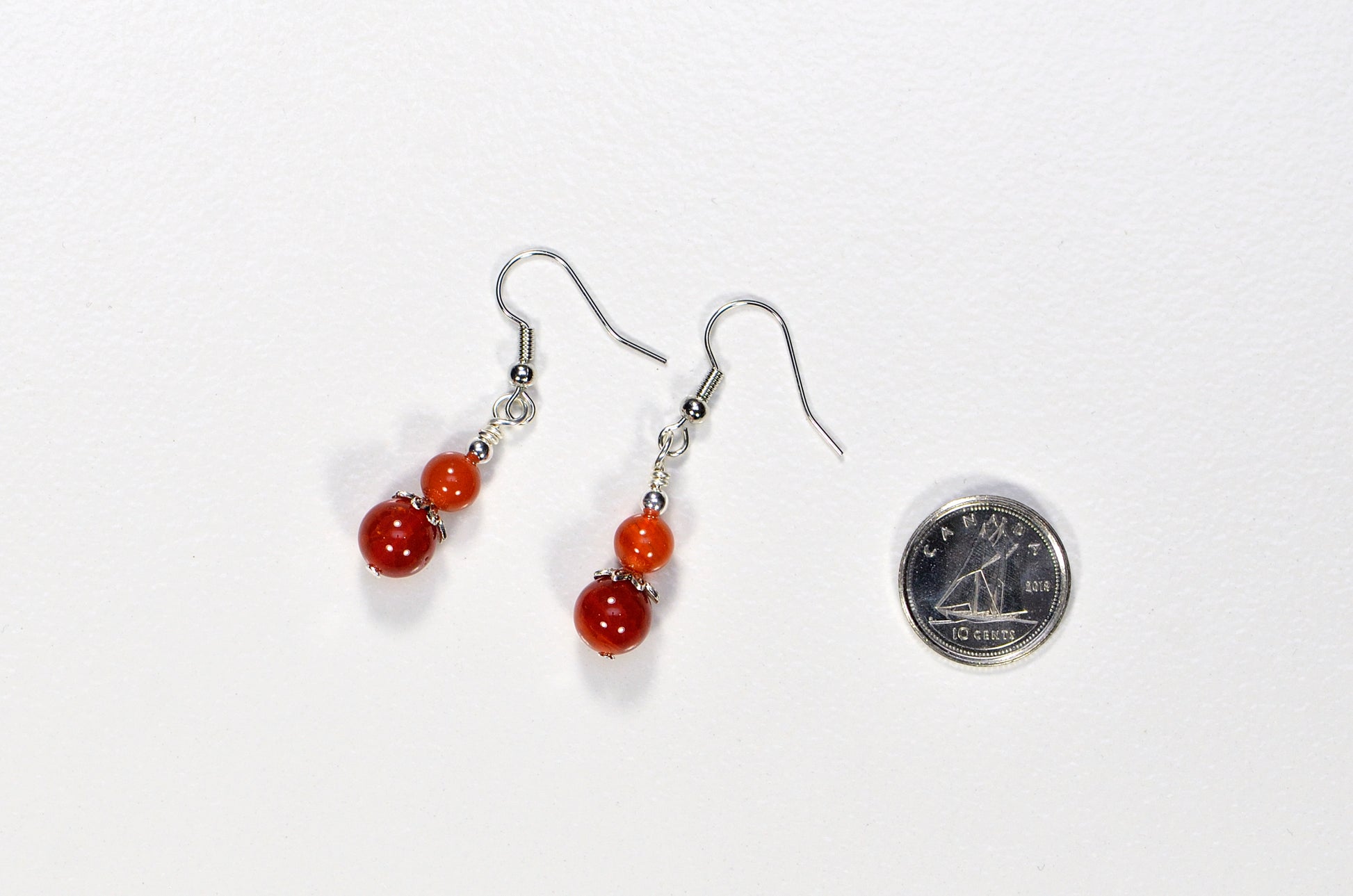 Small Natural Fire Agate Earrings beside a dime.
