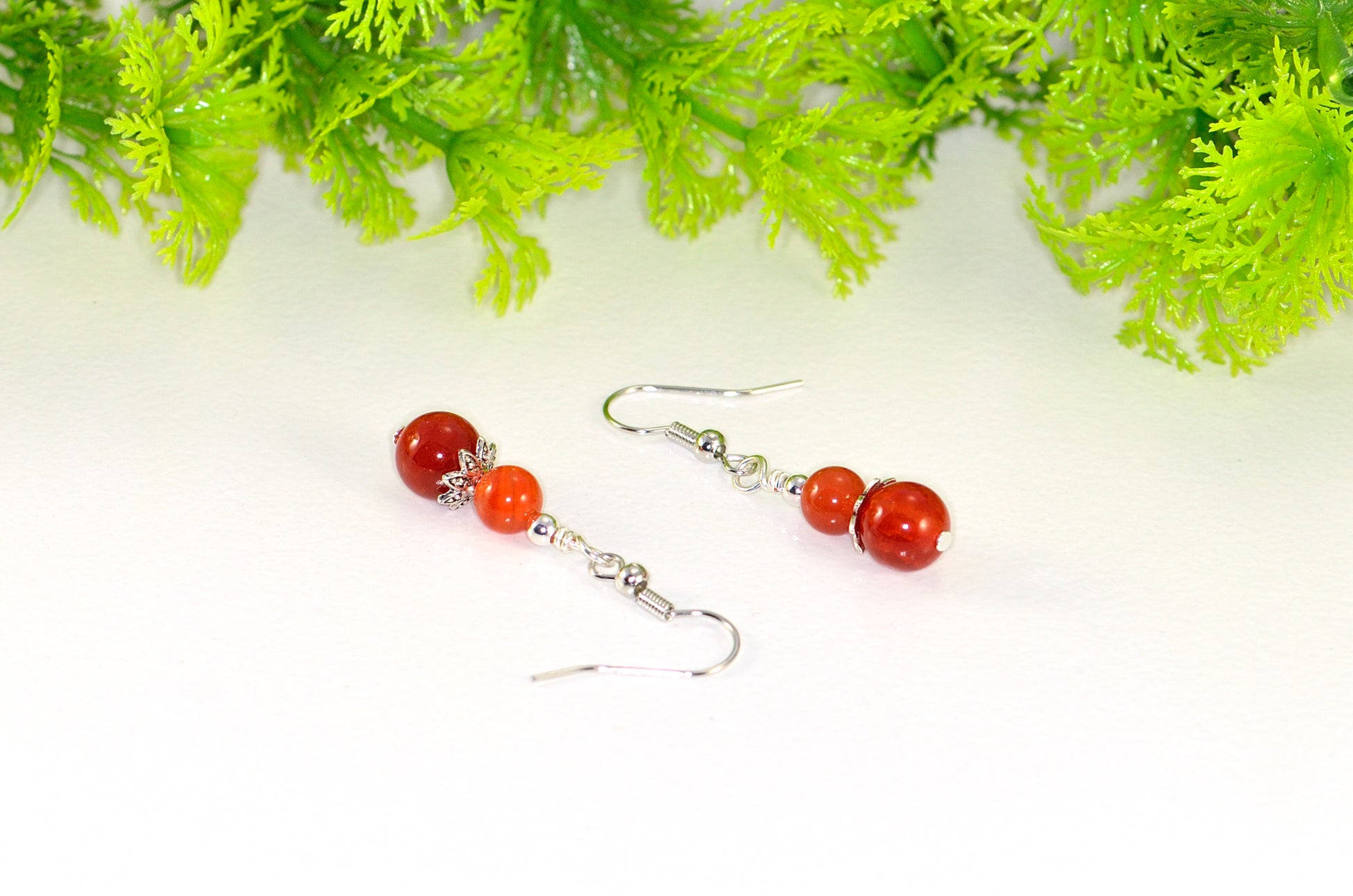 Close up of Small Natural Fire Agate Earrings.