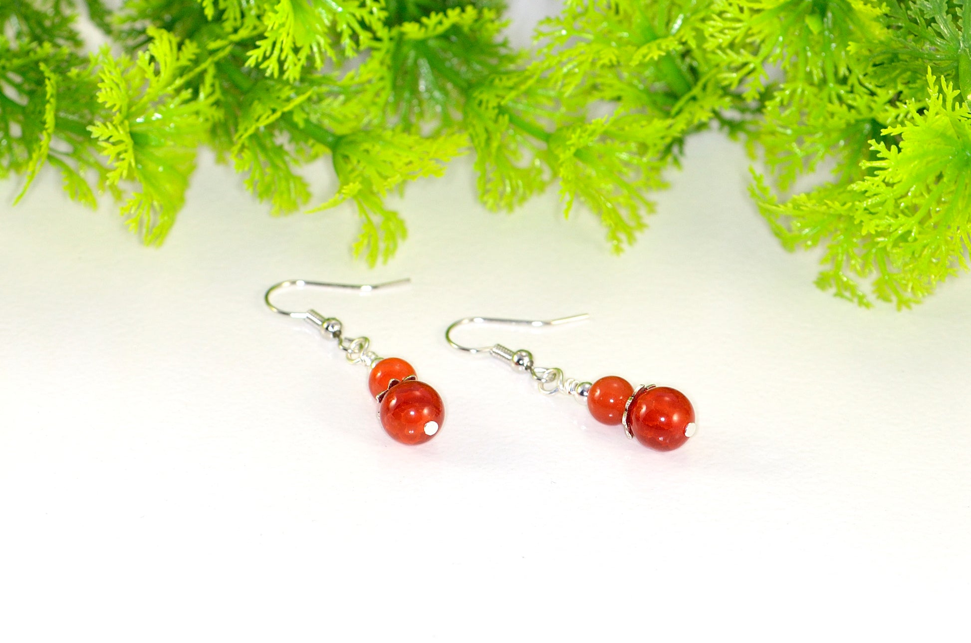 Close up of Small Natural Fire Agate Earrings.