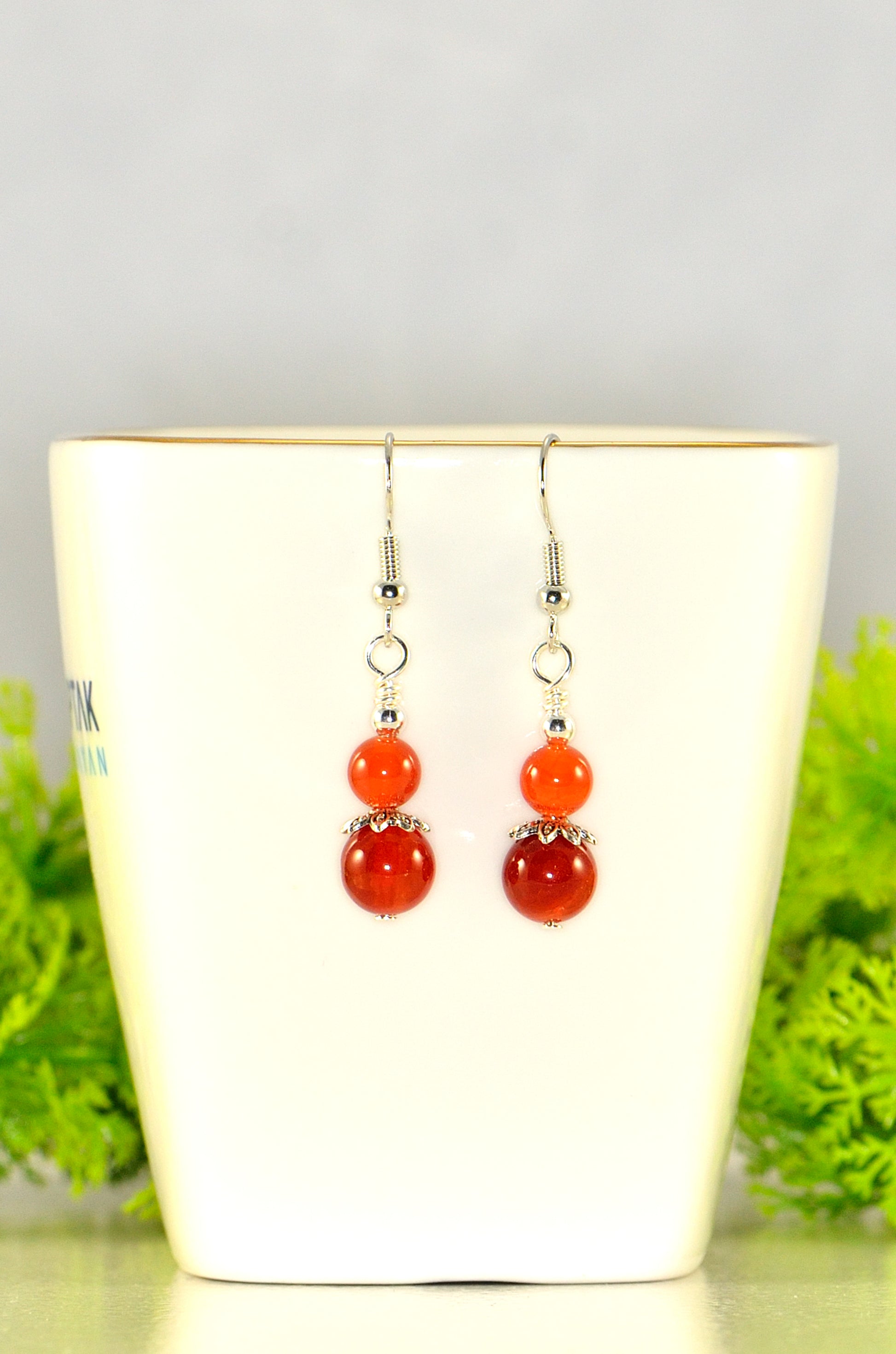 Close up of Small Natural Fire Agate Earrings.