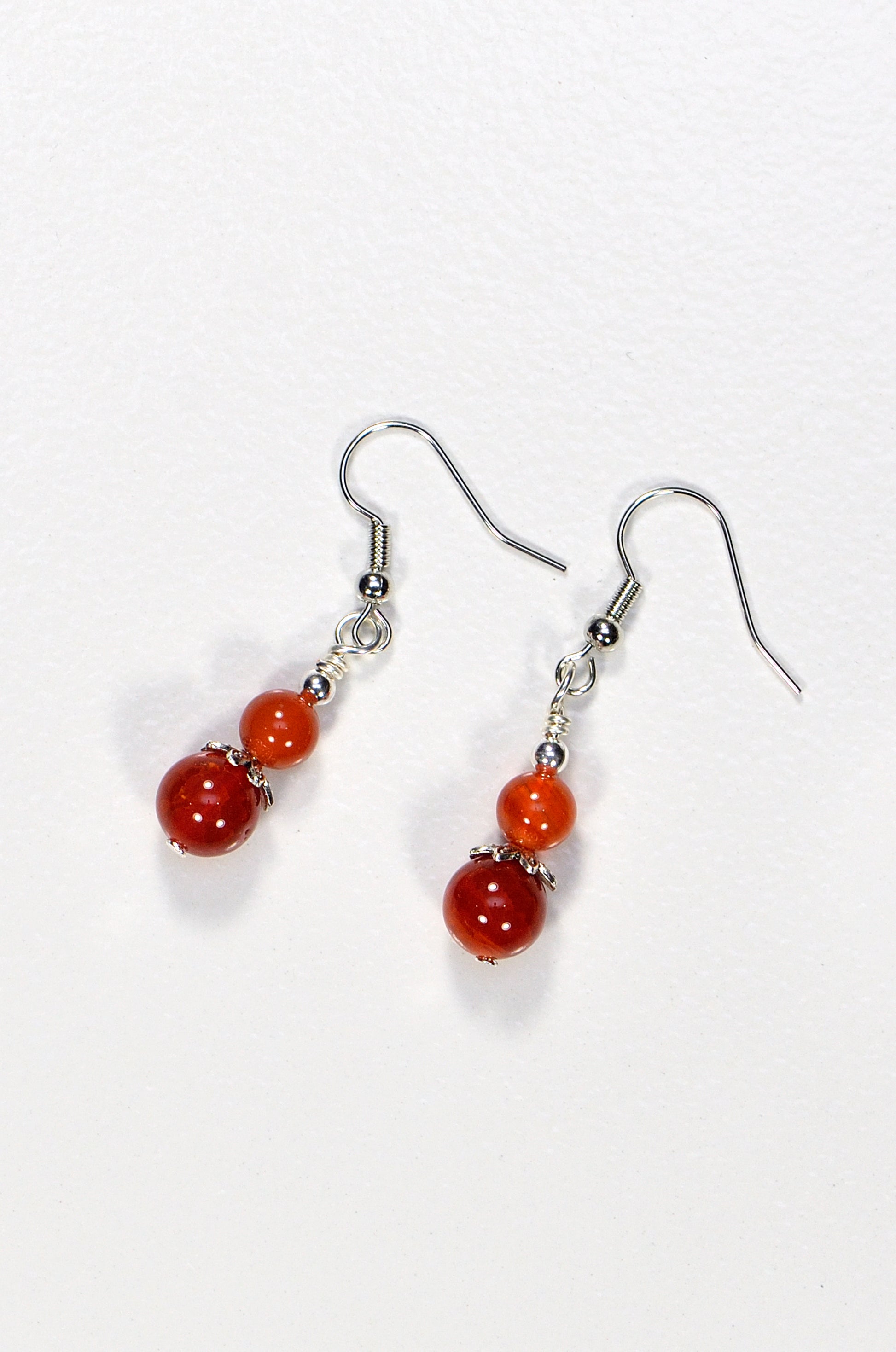 Top view of Small Natural Fire Agate Earrings.