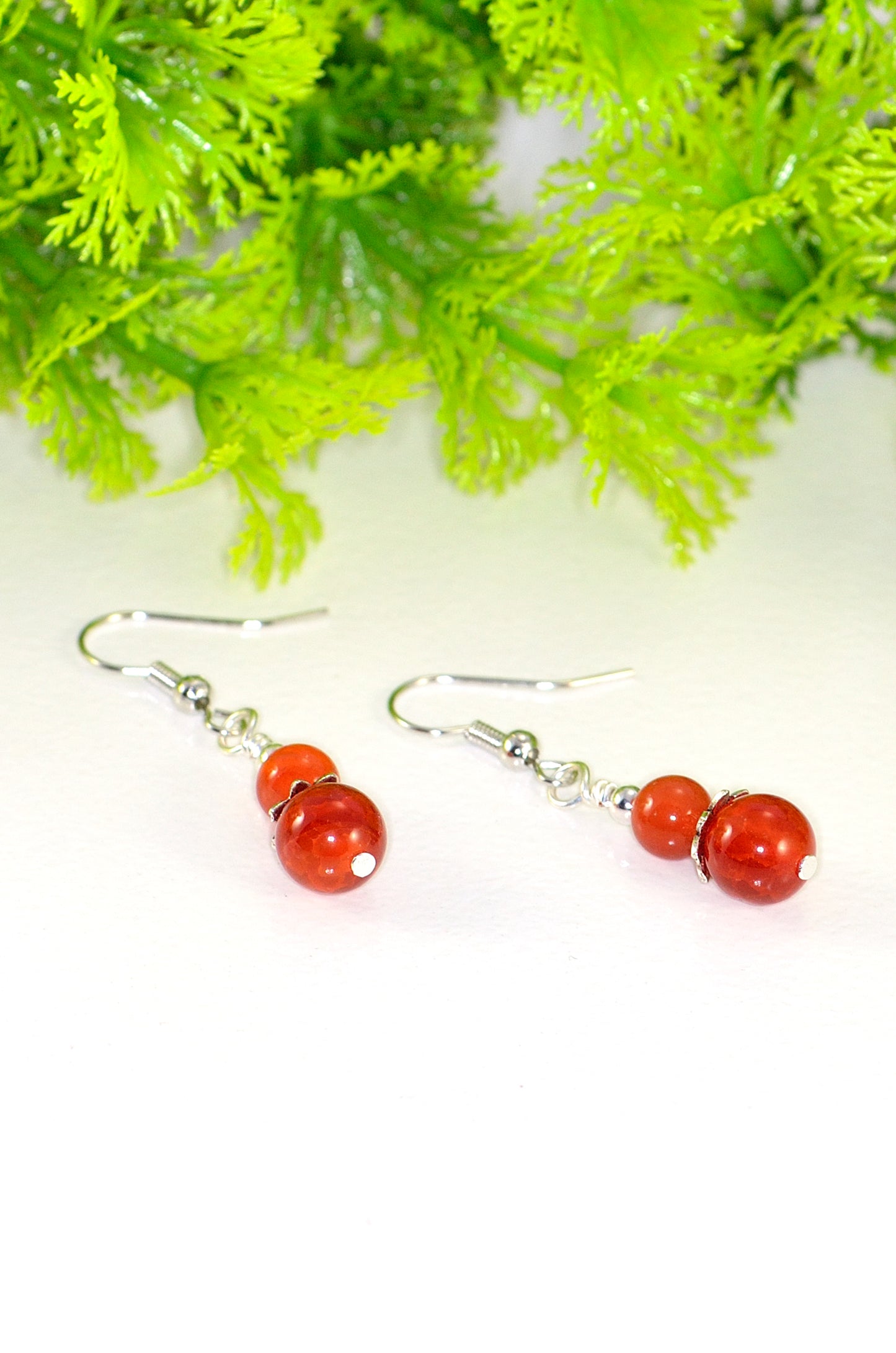 Close up of Small Natural Fire Agate Earrings.