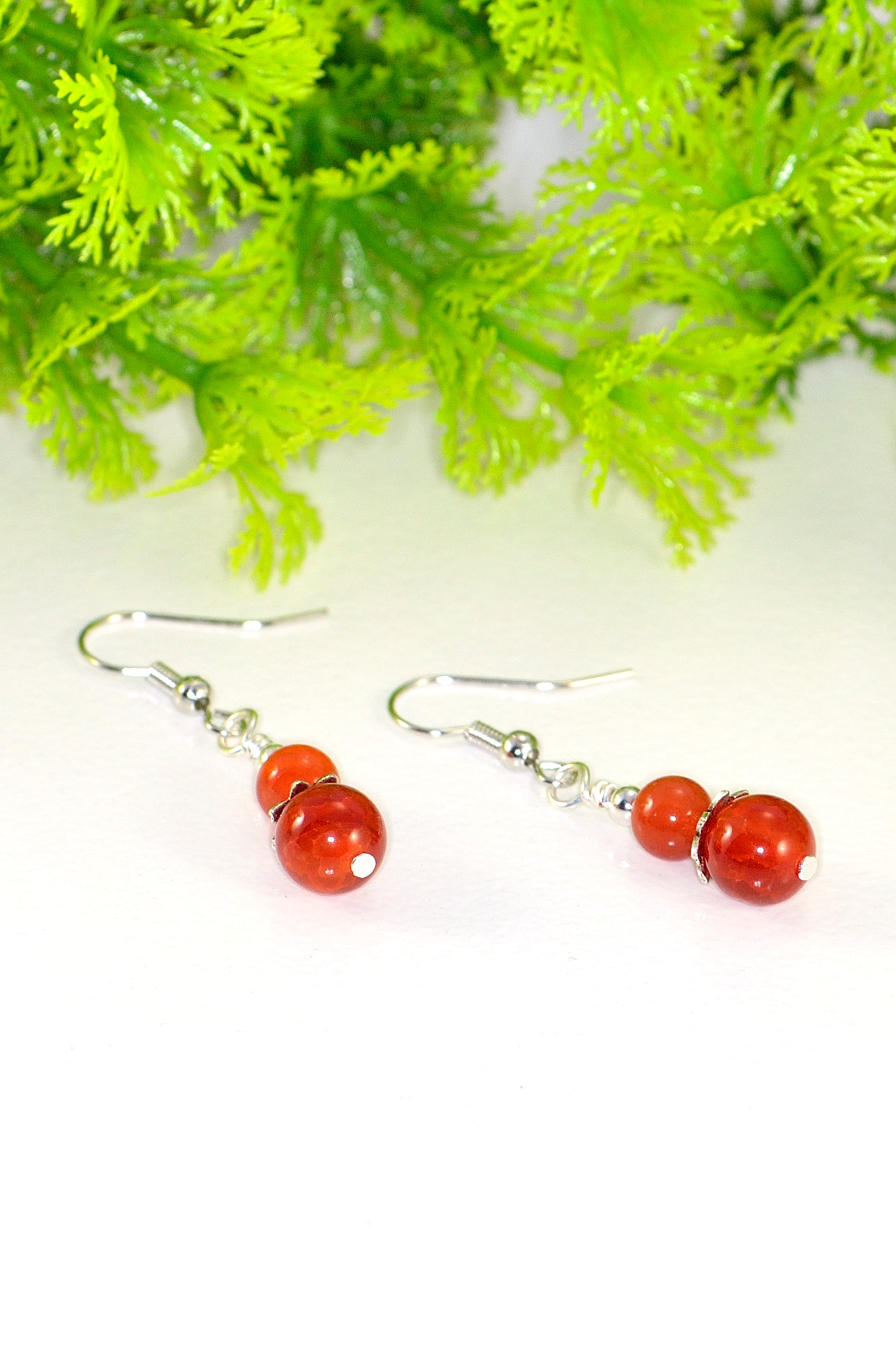 Close up of Small Natural Fire Agate Earrings.