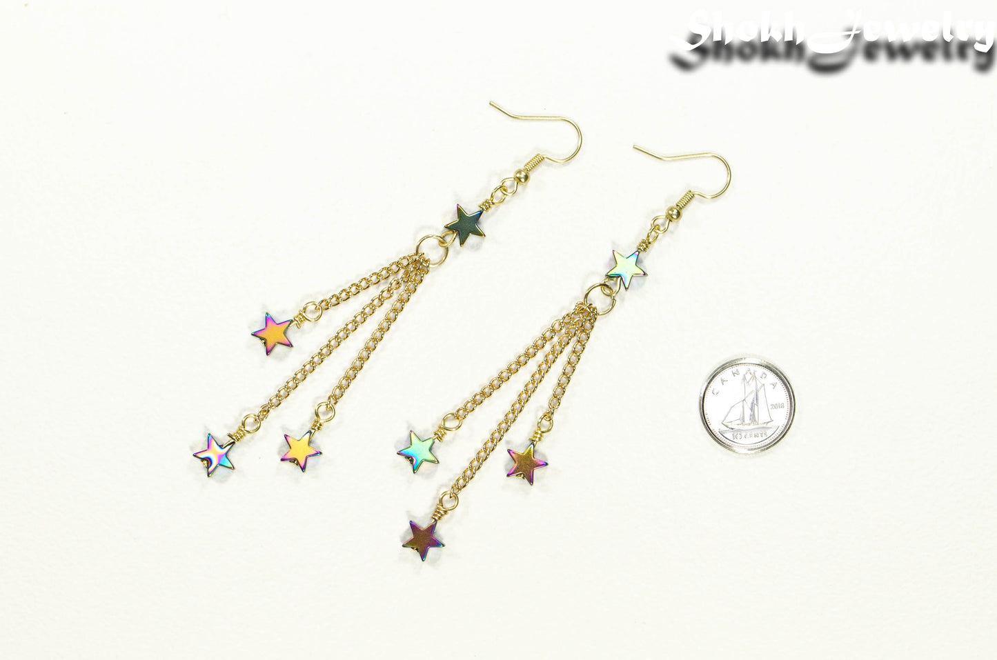 Sparkly Hematite Star and Gold Chain Earrings beside a dime.