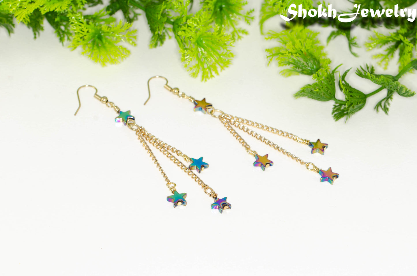 Close up of Sparkly Hematite Star and Gold Chain Earrings.