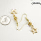 Sparkly Rhinestone and Gold Star Earrings beside a dime.