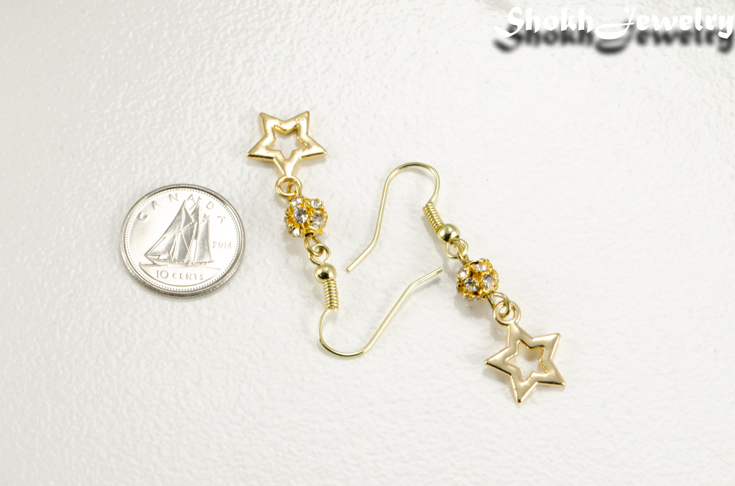 Sparkly Rhinestone and Gold Star Earrings beside a dime.
